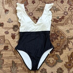 The ruffle flip summersalt swim suit in sea urchin and black sand 10